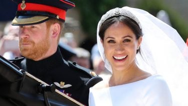 Meghan Markle smiling after her wedding ceremony in a carriage