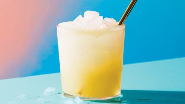 slushy blender lemonade made with meyer lemons on a teal table