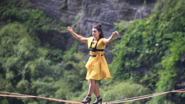 Meet Slackliner Mia Noblet, who walked across a line in a yellow dress and high heels in this photo