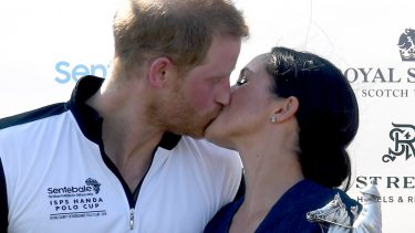 WINDSOR, UNITED KINGDOM - JULY 26: Meghan, Duchess of Sussex and Prince Harry, Duke of Sussex kiss as they pose with the trophy after the Sentebale ISPS Handa Polo at the Royal County of Berkshire Polo Club on July 26, 2018 in Windsor, England.