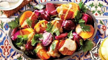 Bowl of brightly coloured beets on blue and red tiles