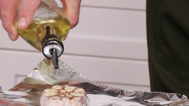Chef Chuck Hughes cooks garlic with oil
