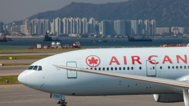 what does the aeroplan deal mean for your points: Air Canada plane at airport with ocean view skyline in back
