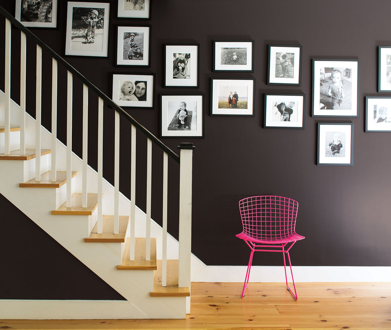 Rich purple on a staircase wall is more dynamic paired with hot pink. Black and white photographs play up the intensity.