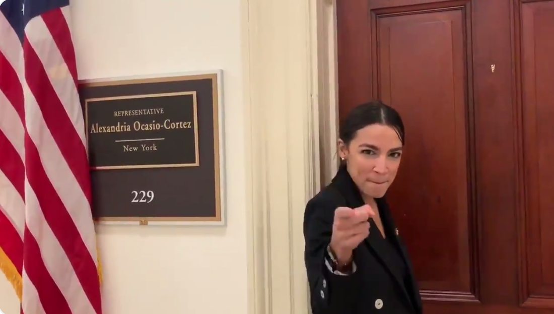 female politicians twitter comebacks: screengrab of alexandria ocasio cortez pointing at camera while dancing in congress building