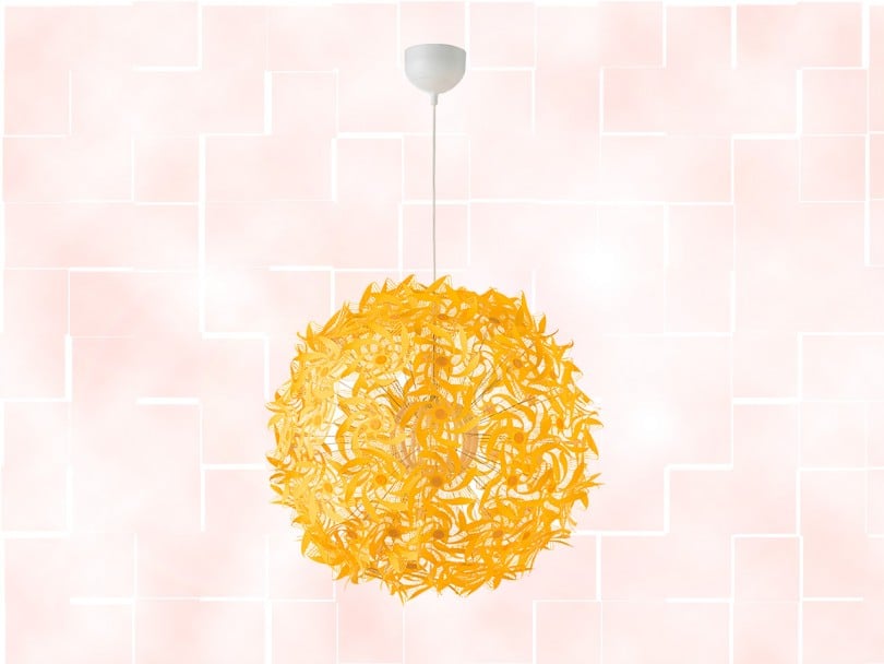 ikea-february-2019: yellow sphere cut out pendant lamp on pink tiled background
