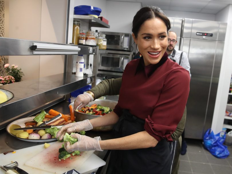 What Does Meghan Markle Do All Day-The Duchess Of Sussex Visits The Hubb Community Kitchen, she stands chopping broccoli