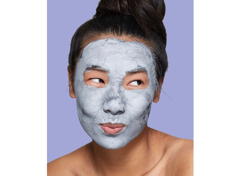 Skincare Myths Busted: woman in clay mask with purple background