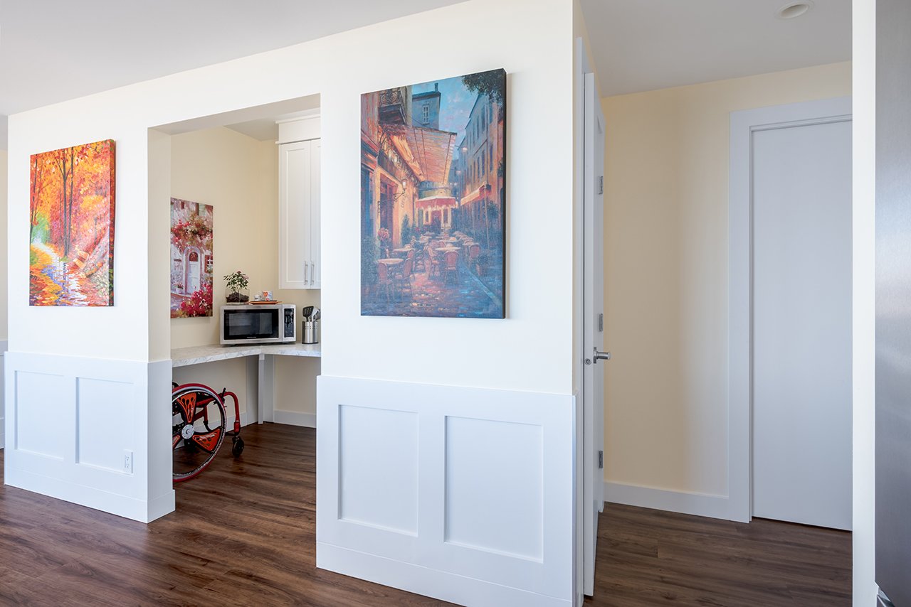 Jenna Reed-Côté's universal design renovations: Foyer area with 2 paintings surrounding entrance to flex room with microwave