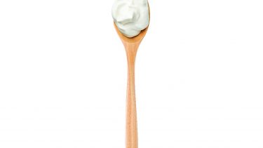 Vegan mayonnaise on a wooden spoon