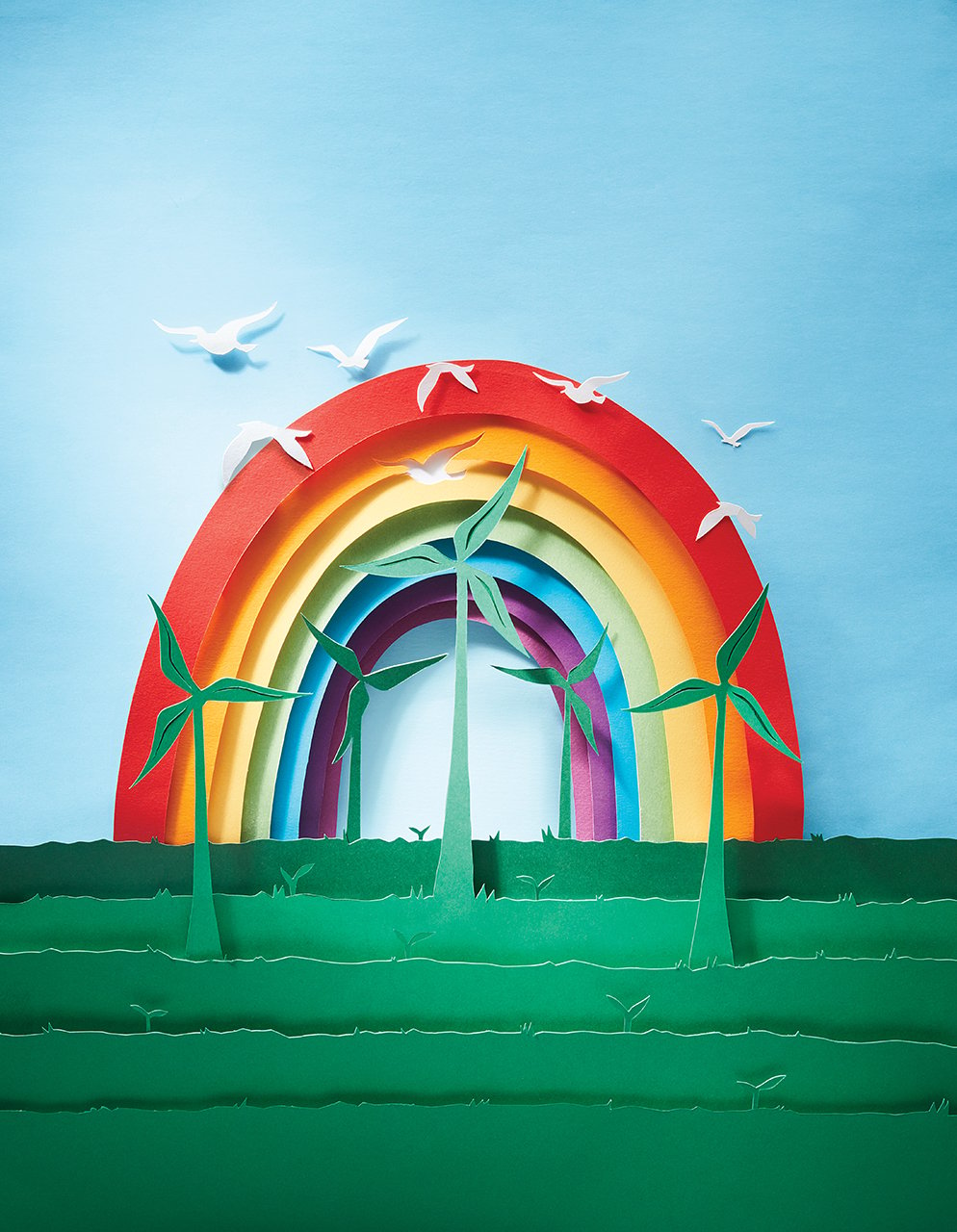 the future is greener than you think — paper rainbow with birds flying above wind turbines