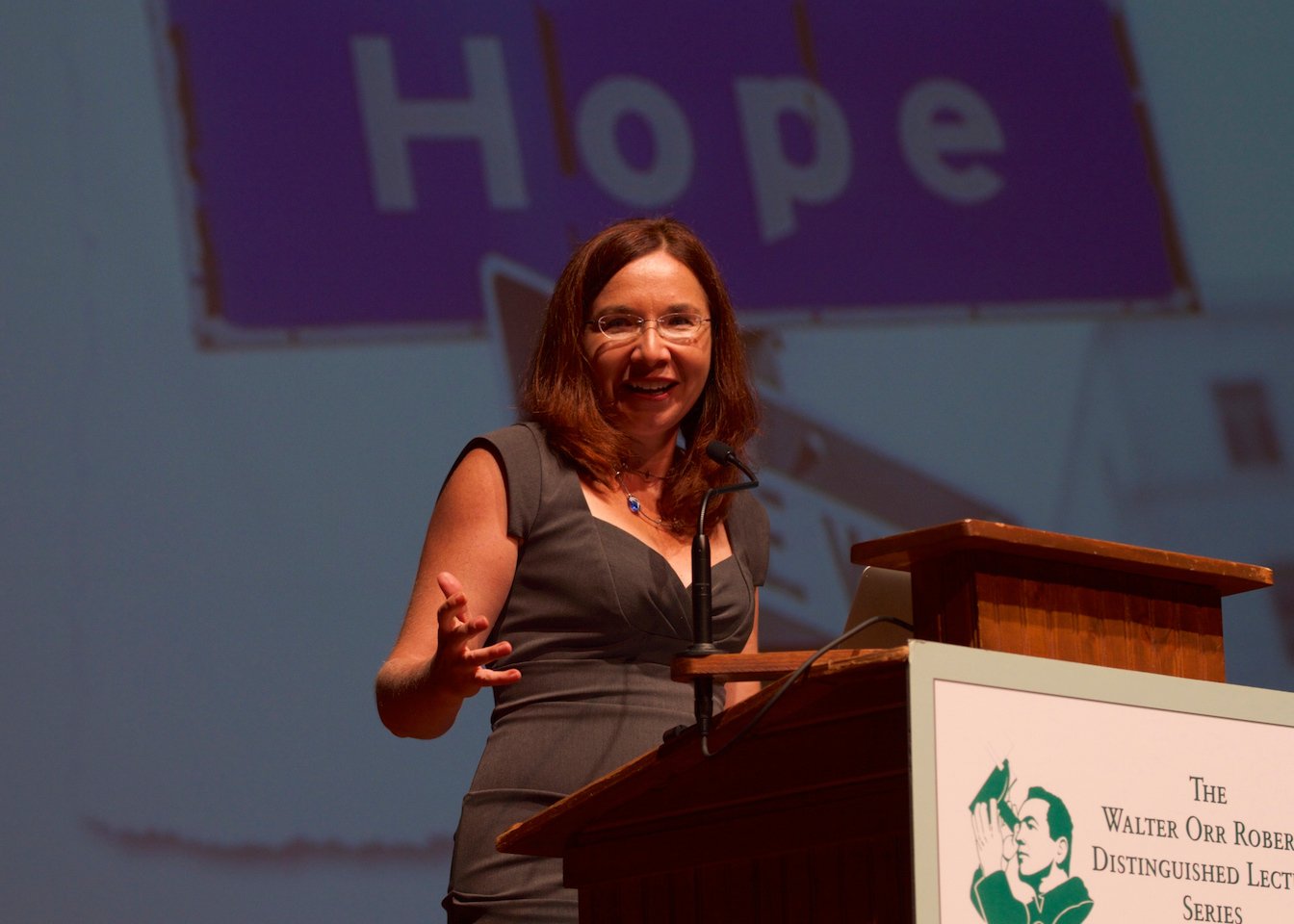 how to talk to a climate change skeptic- author Katharine Hayhoe speaks at a podium