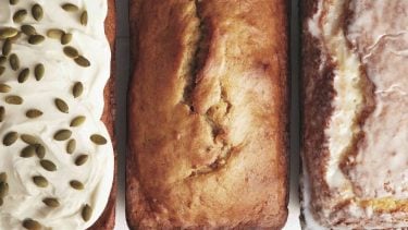 Carrot cake with cream cheese icing, banana bread and lemon loaf in a row