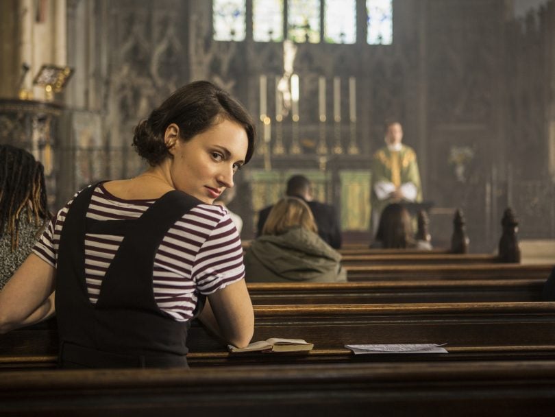 Phoebe Waller-Bridge, in her BBC comedy Fleabag. She is sitting in a church pew and looking back over her shoulder.
