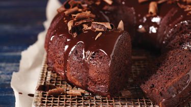 Gluten free chocolate fudge cake from bundt mold with sliced piece
