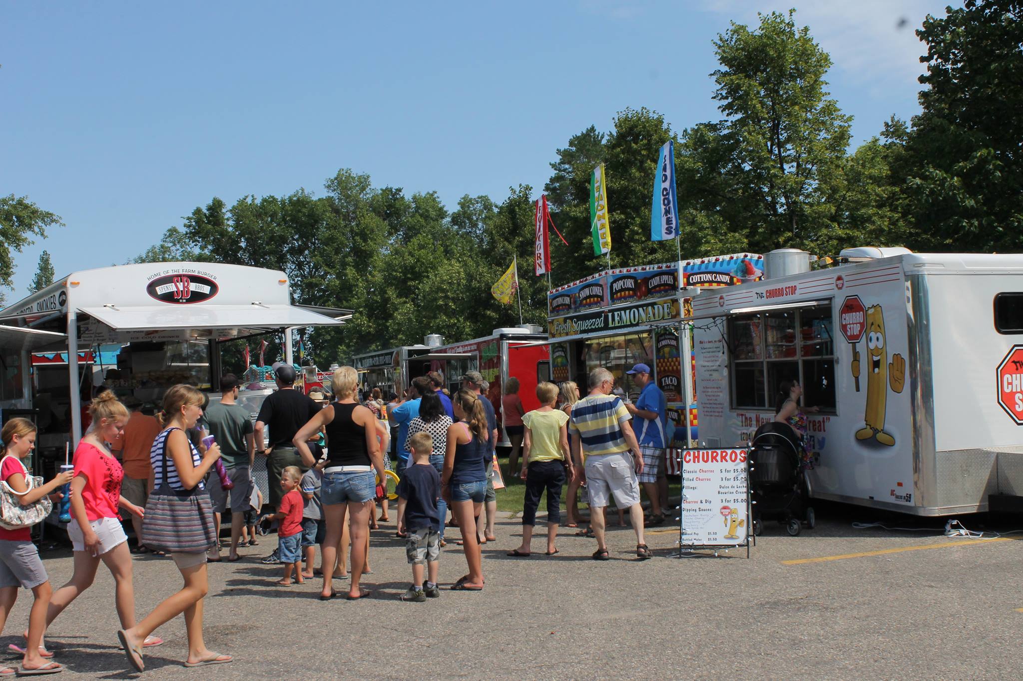 Festival-goers at the Manitoba Sunflower Festival waiting in line at a food truck.