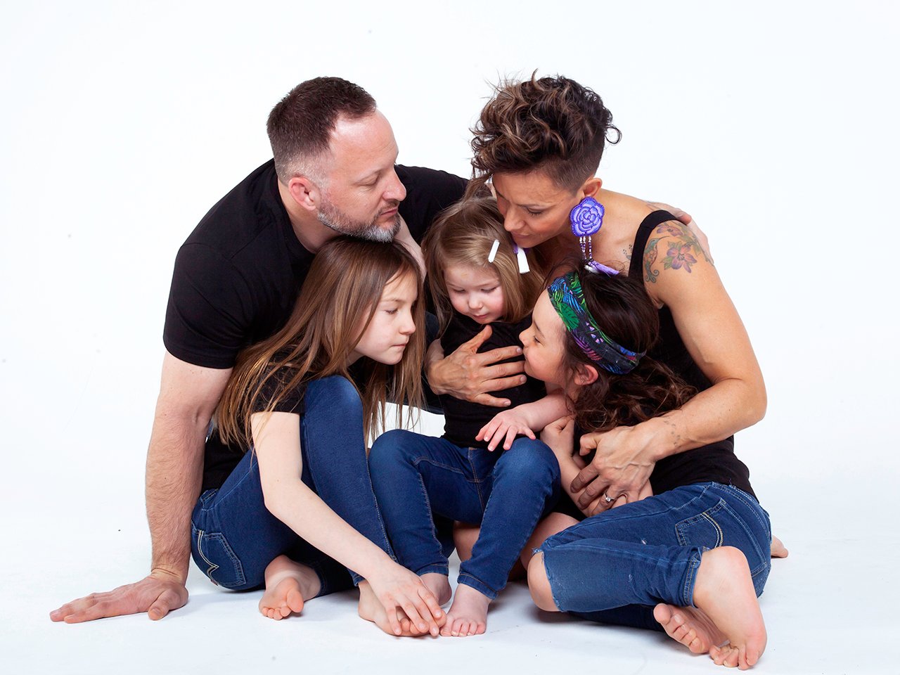 Waneek Horn-Miller and husband hold their three children in photoshoot