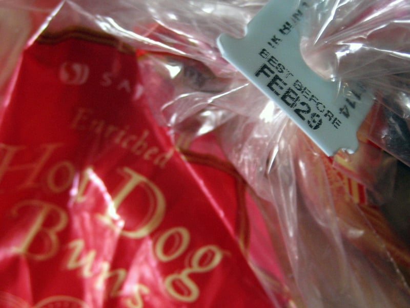 reuse single-use plastics: light blue bread tag "best before feb 29" on hot dog buns bag