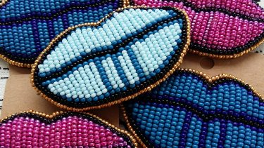 Indigenous accessories designers: Iskwew Rising beaded lips in pink and blue