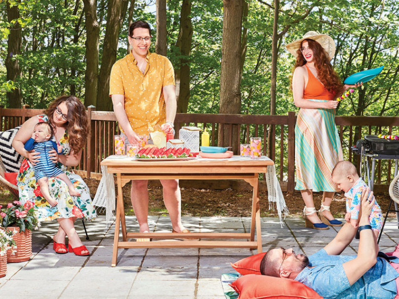 Polyamorous parenting: a polyamorous family (two men, two women, two babies) having a backyard BBQ