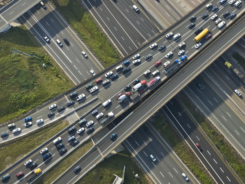 Aerial view of a gridlocked overpass on a large highway interchange — carbon levels at highest in human history