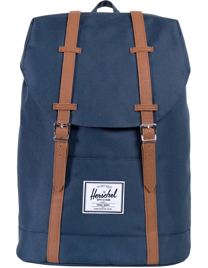 Navy blue Herschel backpack on a white background.