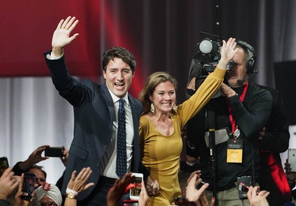 Liberal leader Justin Trudeau and wife Sophie Gregoire Trudeau wave as they go on stage at Liberal election headquarters in Montreal, Monday, Oct. 21, 2019. 