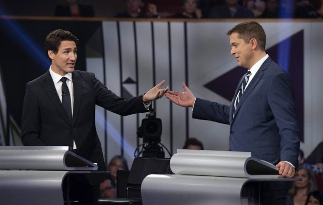 Conservative leader Andrew Scheer, right, and Liberal leader Justin Trudeau gesture to each other as they both respond during the Federal leaders debate in Gatineau, Que. on Monday, October 7, 2019. THE CANADIAN PRESS/Justin Tang