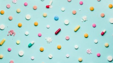 Pretty pills against a backdrop of blue