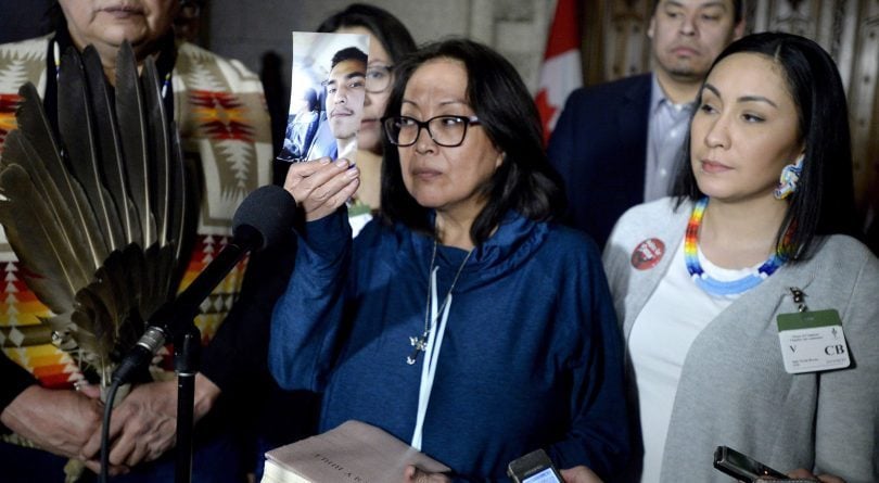 Mother of Colten Boushie holds up photo of her son in the House of Commons