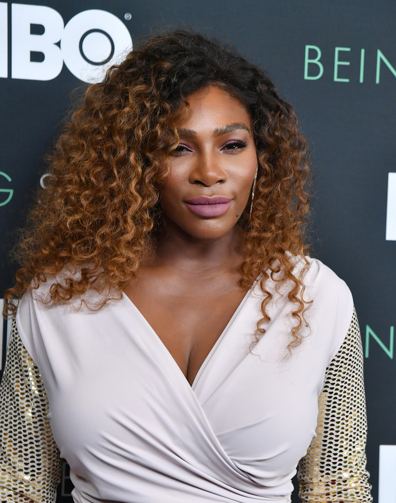 serena williams with curly brown hair wearing a white dress
