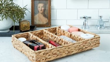 a woven cutlery tray used to organize makeup and soap