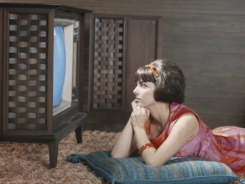 Young woman watching television