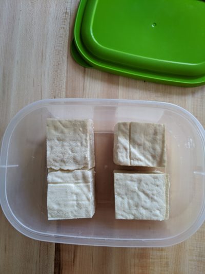 cubed tofu in a plastic container