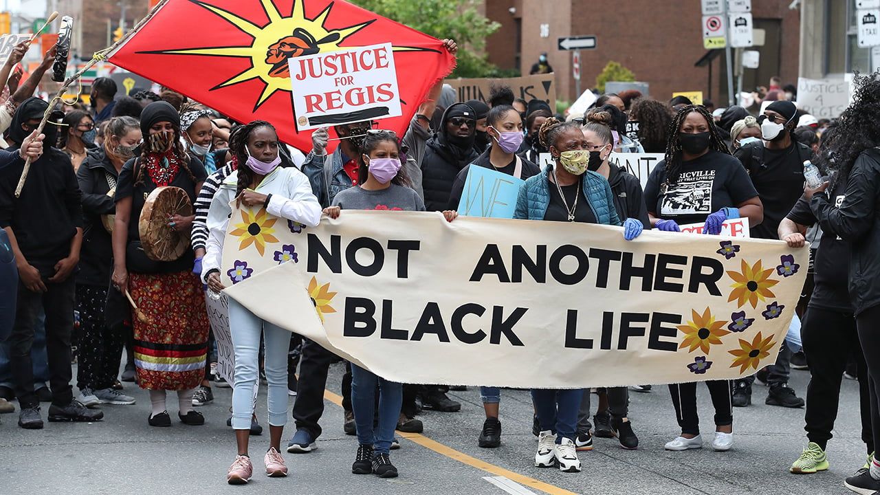 A photo of a march to police headquarters in Toronto on May 30, 2020, in honour of 29-year-old Regis Korchinski-Paquet, who fell from the 24th-floor balcony of an apartment building during an interaction with police. 