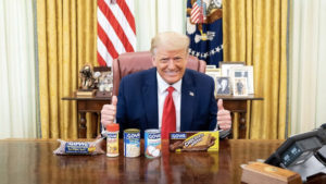 Donald Trump in the Oval Office giving thumbs up behind a bunch of Goya products for a piece on companies that support Trump