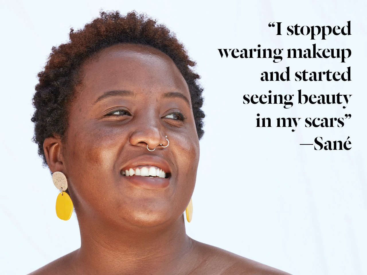 A photo of a Black woman with short hard and glowing skin, wearing yellow circular earrings
