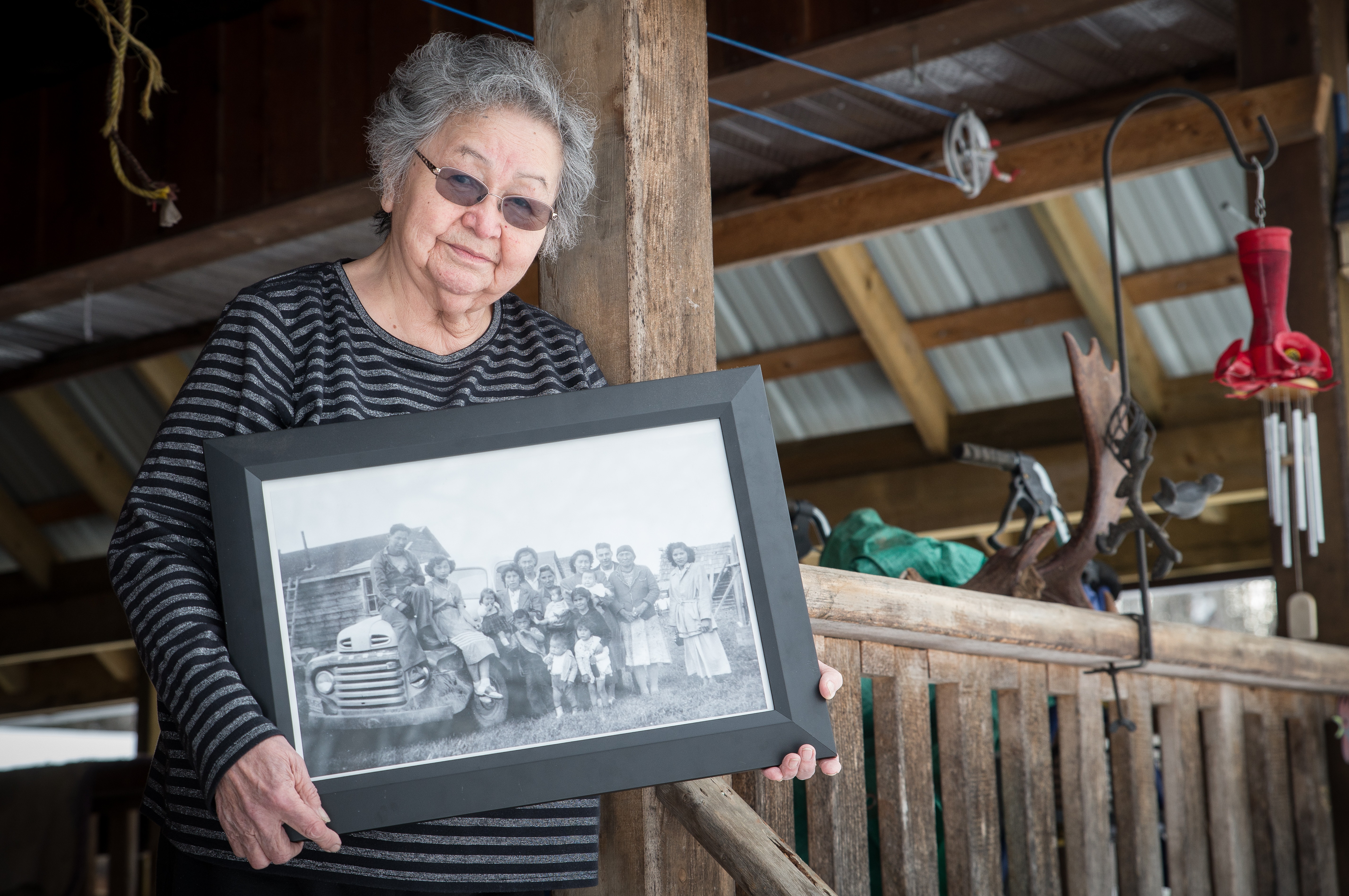 Violet Gellenbeck holding a photo from the 1950s