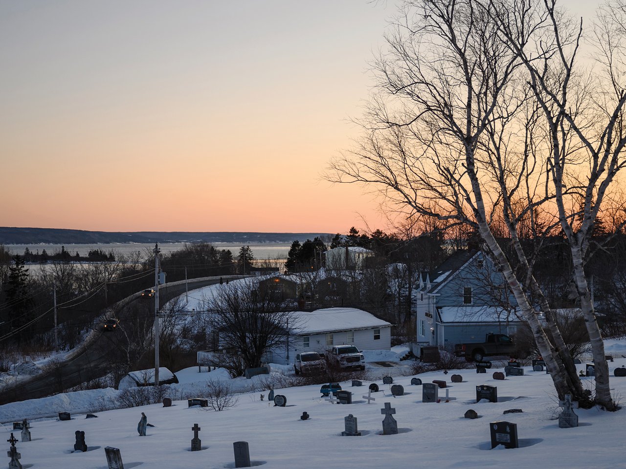 A photo of a hillside cemetary at dusk