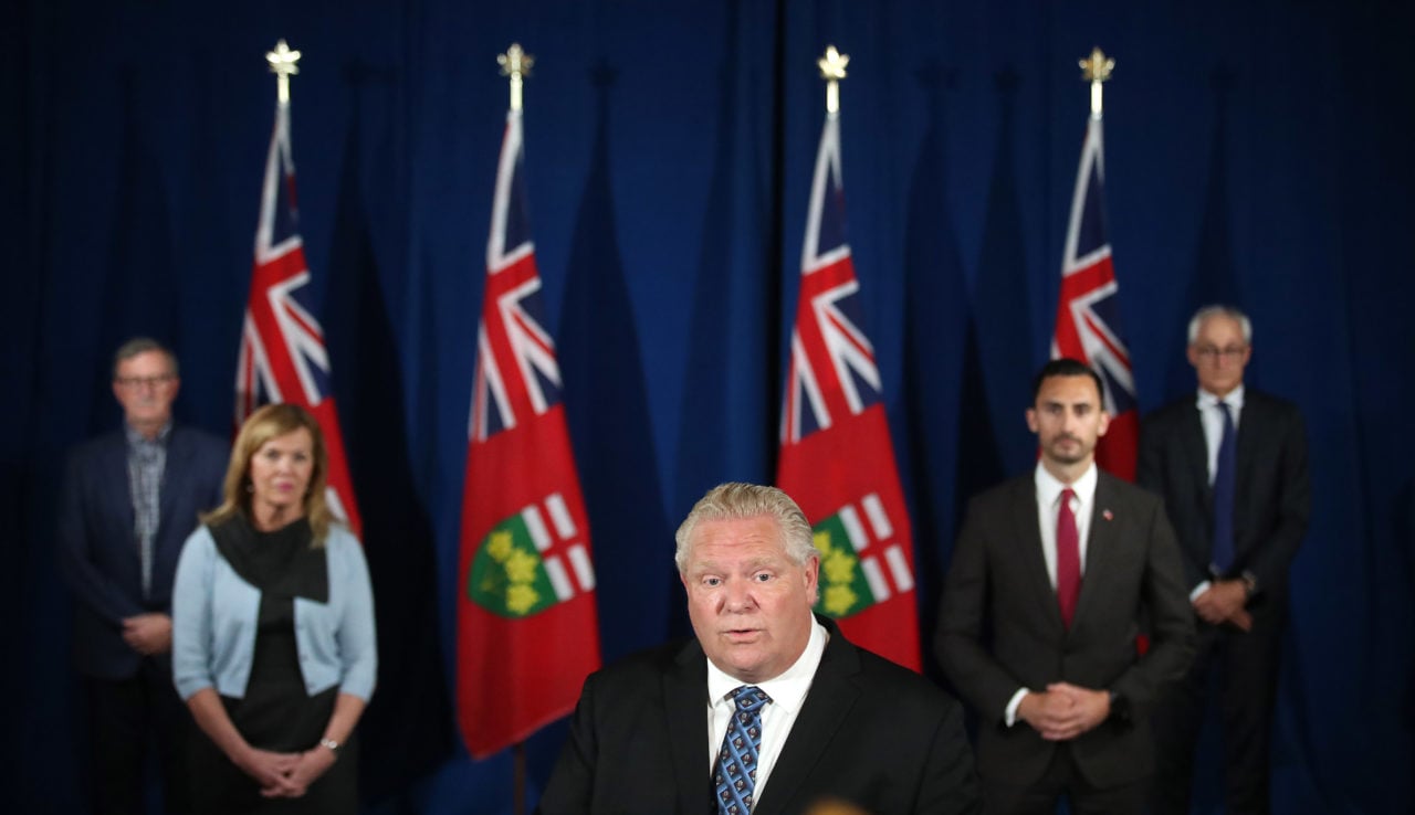 Premier Doug Ford holds at a June press briefing, joined by Minister of Health, Christine Elliott, Minister of Education, Stephen Lecce, Dr. David Williams, Chief Medical Officer of Health, and Ontario's chief coroner Dr. Dirk Huyer.
