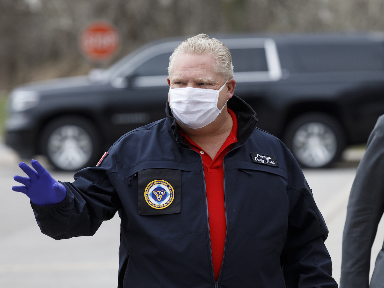 A photo of Doug Ford in a mask and gloves. 