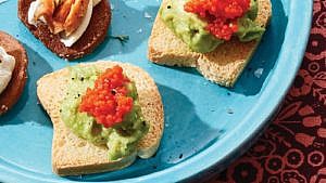 Close up of vegan caviar avocado toasts on blue plate