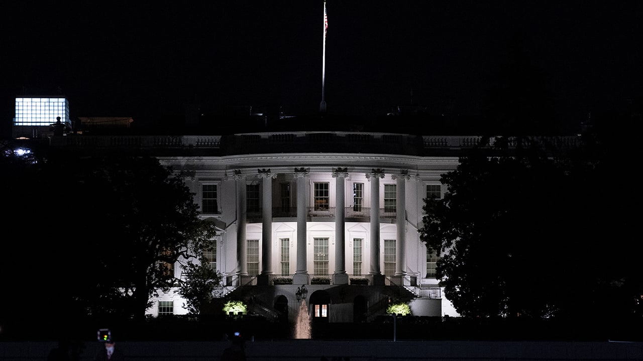 The lit-up exterior of the White House at night in a photo taken the night before the U.S. election