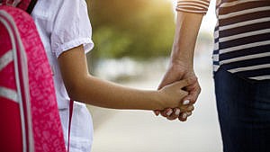 A mother and daughter holding hands to illustrate a piece on parenting through an anxiety disorder