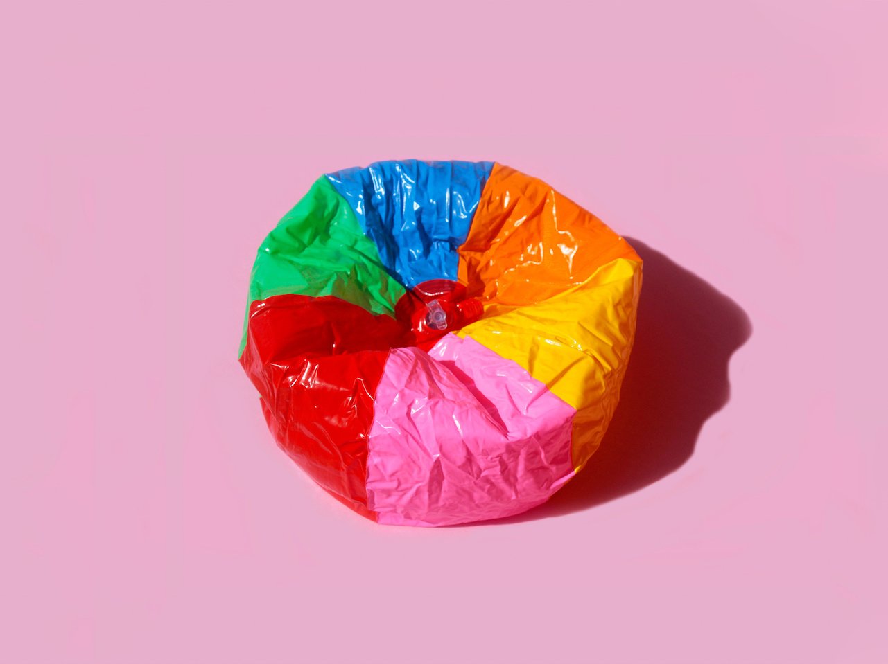 A photo of a colourful deflated beach ball