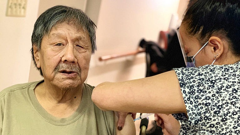 Josephee Adams, 70, a resident of the Iqaluit Elders’ Centre, is Nunavut’s first vaccine recipient. (Arctic Nursing Program). (CP/HO-Government of Nunavut)