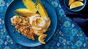 Herb Crusted Haddock recipe on blue plate with cauliflower mash and lettuce wedges