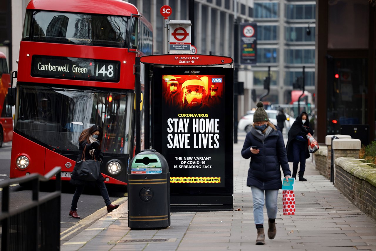 A digital display at a bus station warns pedestrians of the new strain of coronavirus in central London on January 8, 2021