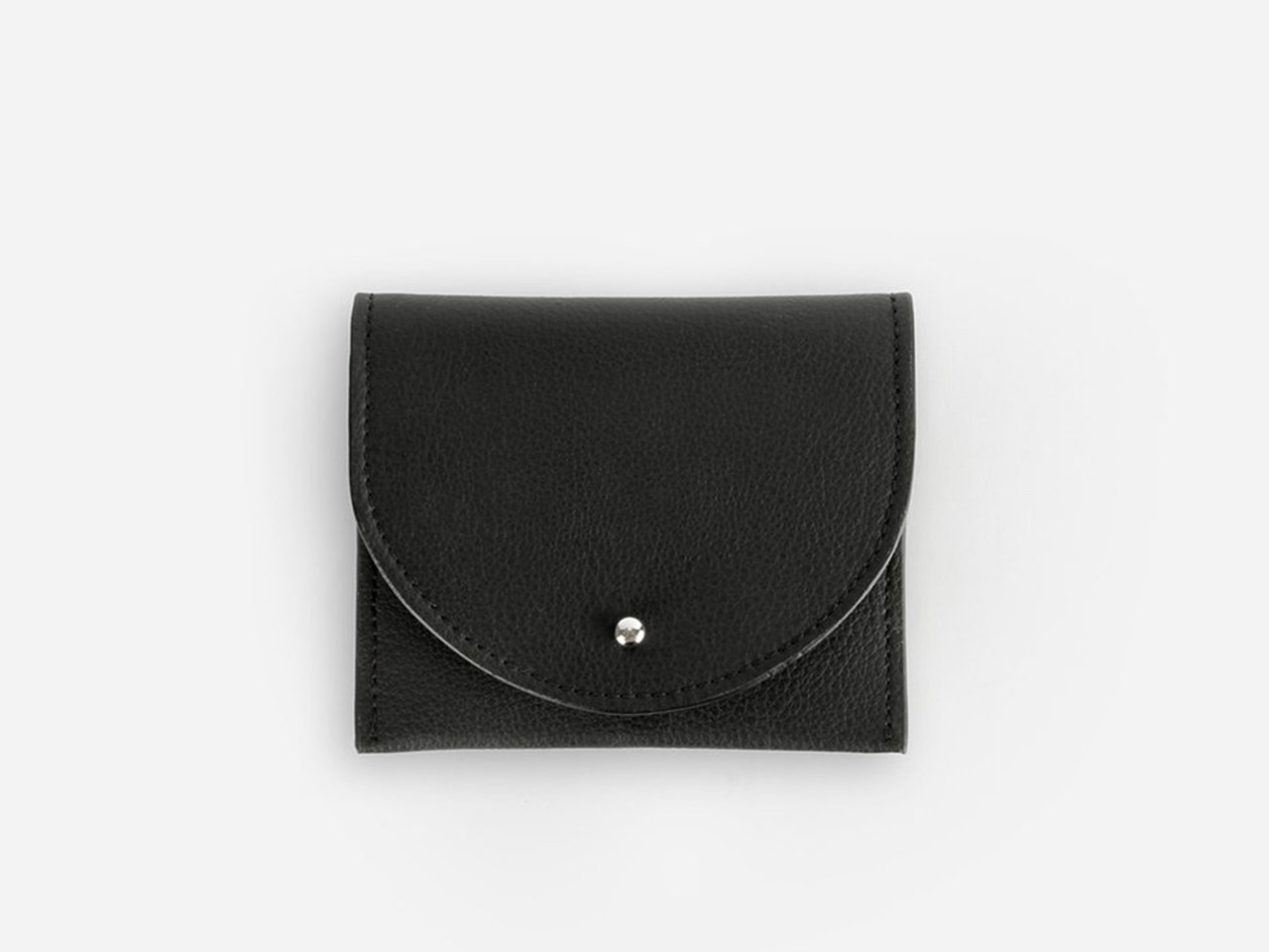 A black card holder made from cactus leather on a white background.