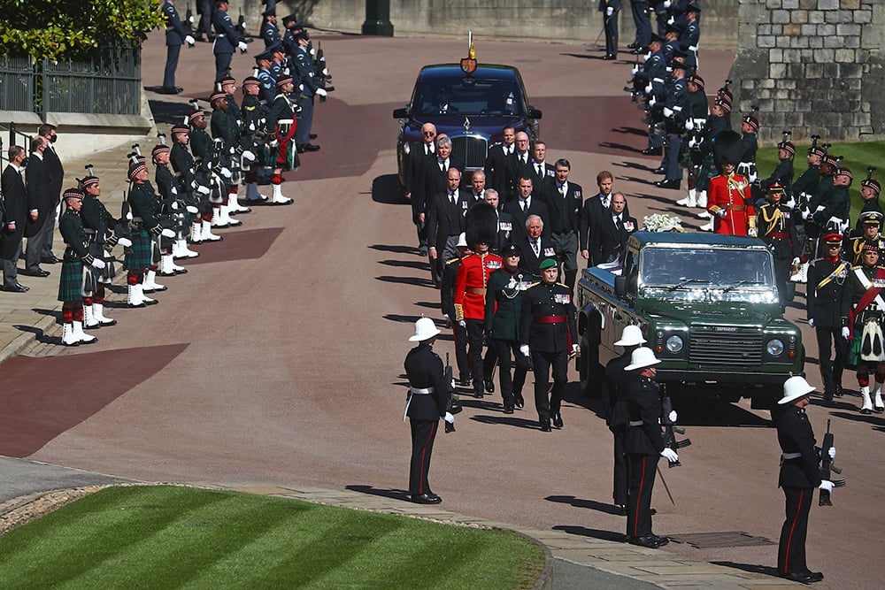 A modified Land Rover hearse carries the coffin as members of the Royal Family follow behind during the ceremonial funeral procession of Prince Philip, Duke of Edinburgh to St George's Chapel in Windsor Castle in Windsor, west of London, on April 17, 2021. (Photo: Hannah McKay / Pool / AFP via Getty Images)